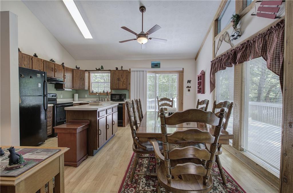 214 South View Trail Jasper, GA 30143 - Photo 11 of 72 a kitchen with stainless steel appliances granite countertop a stove a refrigerator a sink dishwasher a dining table and chairs with wooden floor