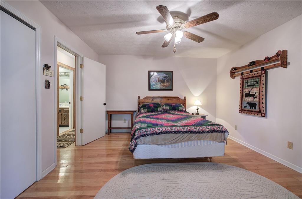 214 South View Trail Jasper, GA 30143 - Photo 20 of 72 a bedroom with a bed and a chandelier