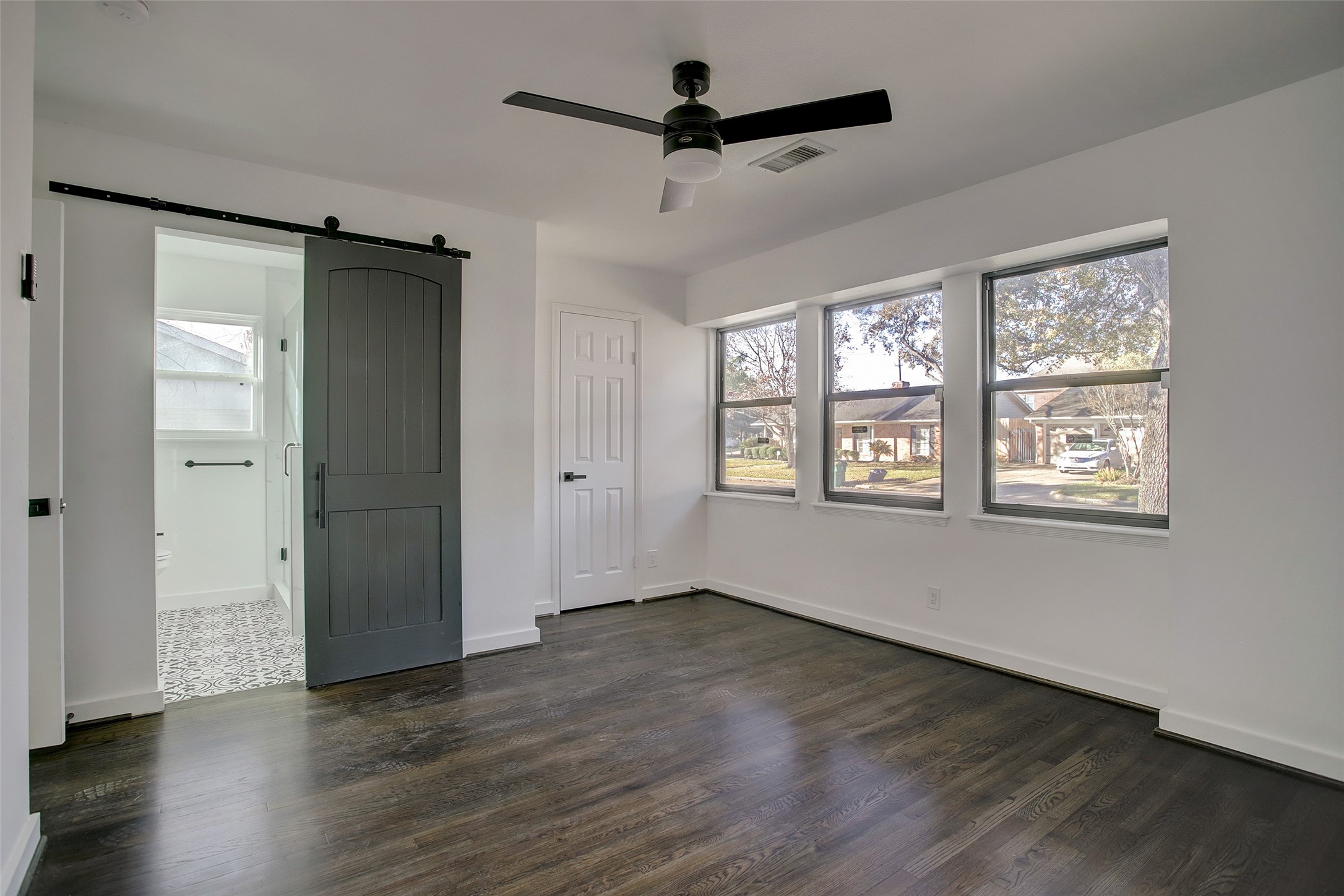 5531 Jason Street Houston, TX 77096 - Photo 2 of 8 a view of an empty room with wooden floor and a window