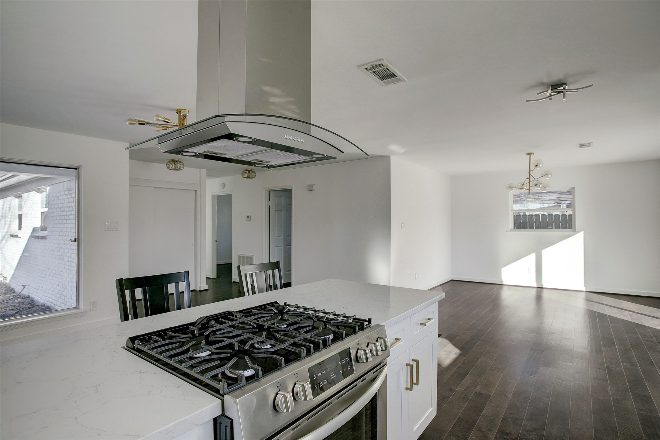 5531 Jason Street Houston, TX 77096 - Photo 3 of 8 a kitchen with a stove and wooden floor