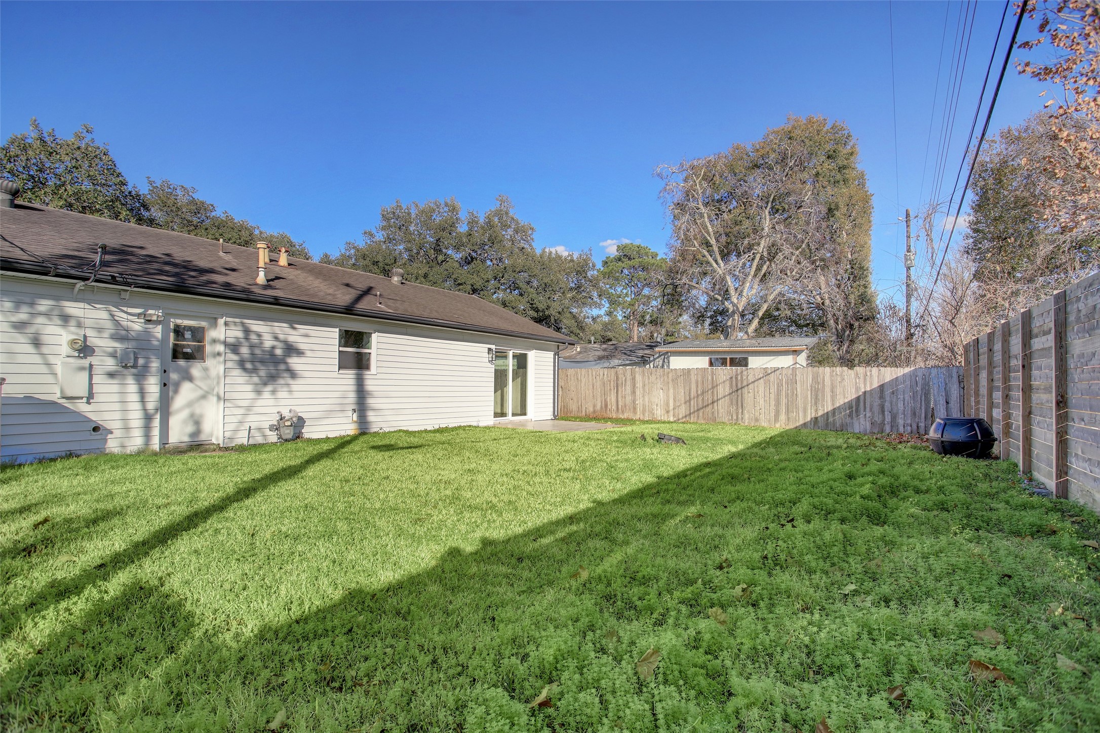 5531 Jason Street Houston, TX 77096 - Photo 6 of 8 a view of a backyard with plants and large trees