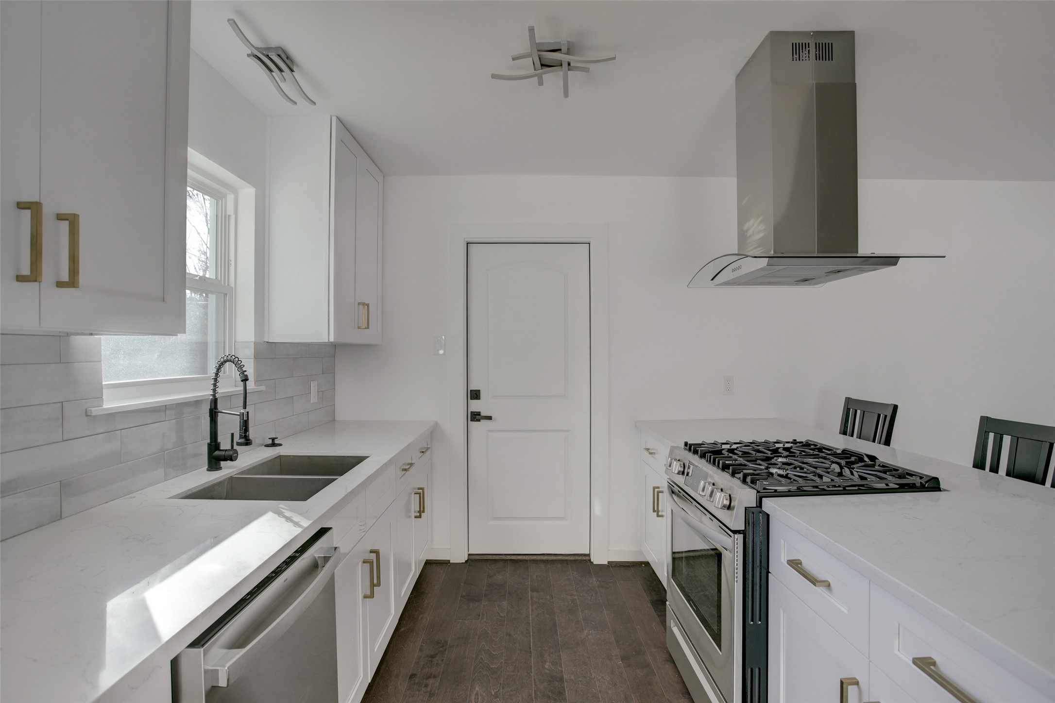 5531 Jason Street Houston, TX 77096 - Photo 7 of 8 a kitchen with a sink stove and cabinets