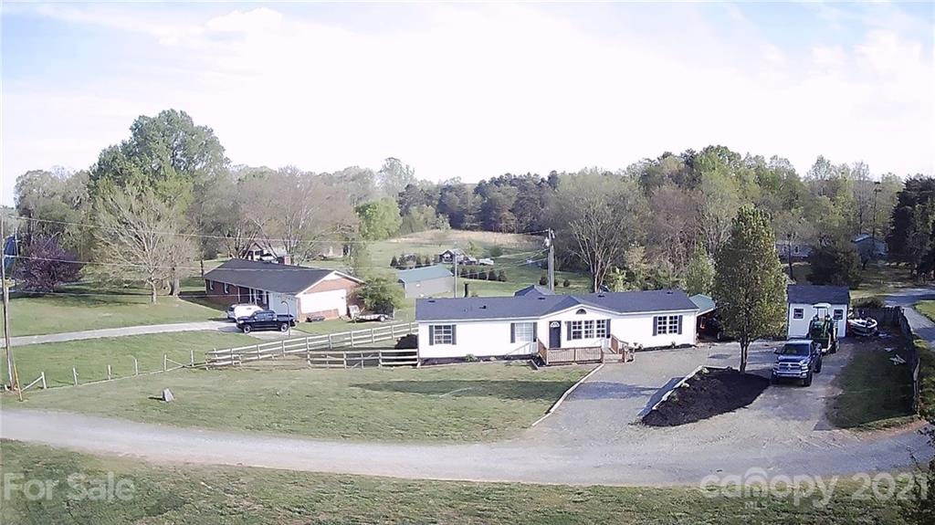 7815 Stokes Ferry Road Salisbury, NC 28146 - Photo 1 of 14 a view of houses with yard and road