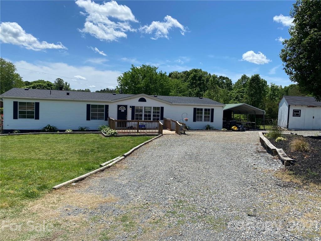 7815 Stokes Ferry Road Salisbury, NC 28146 - Photo 13 of 14 a front view of a house with a garden and yard