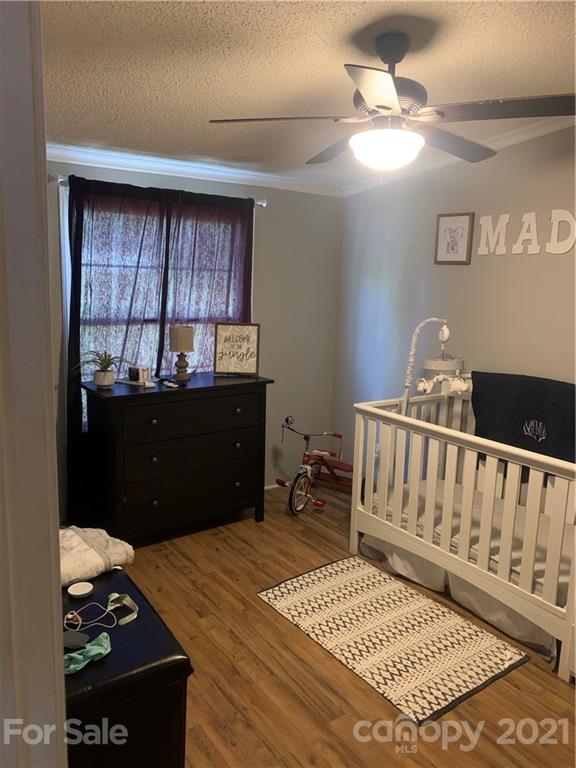 7815 Stokes Ferry Road Salisbury, NC 28146 - Photo 7 of 14 a bedroom with a bed and a table