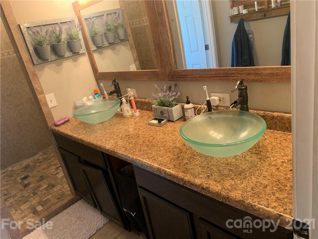 7815 Stokes Ferry Road Salisbury, NC 28146 - Photo 10 of 14 a bathroom with a sink and a mirror