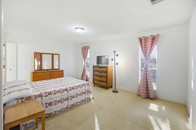 a bedroom with a bed and a chair