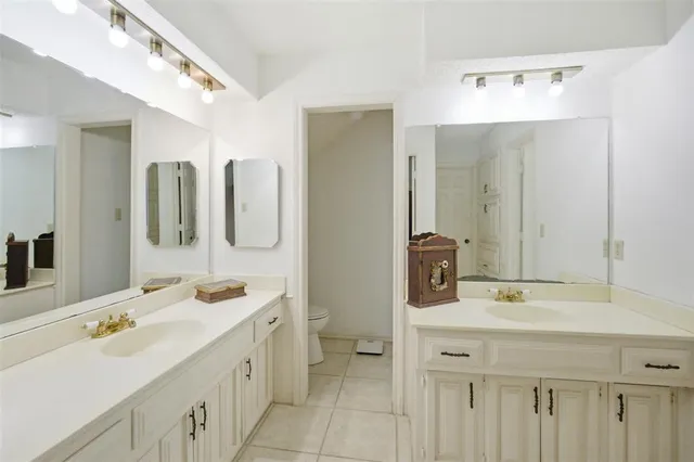 a bathroom with a double vanity sink mirror and
