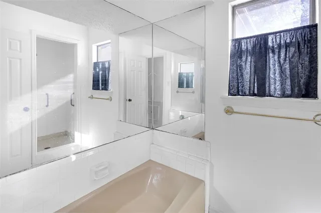 a bathroom with a bathtub and a shower