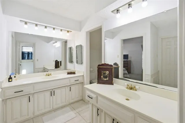 a bathroom with a double vanity sink mirror and double