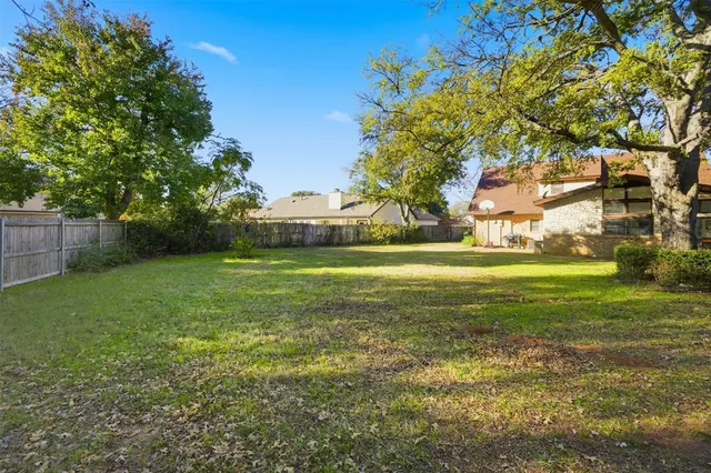 a view of a park with large trees