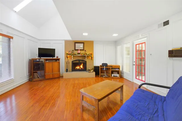 a living room with furniture a flat screen tv and a fireplace