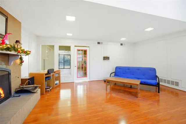 a room with furniture pool table and a fireplace