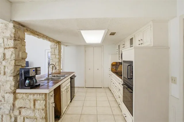 a kitchen with stainless steel appliances kitchen island granite countertop a refrigerator and a stove top oven