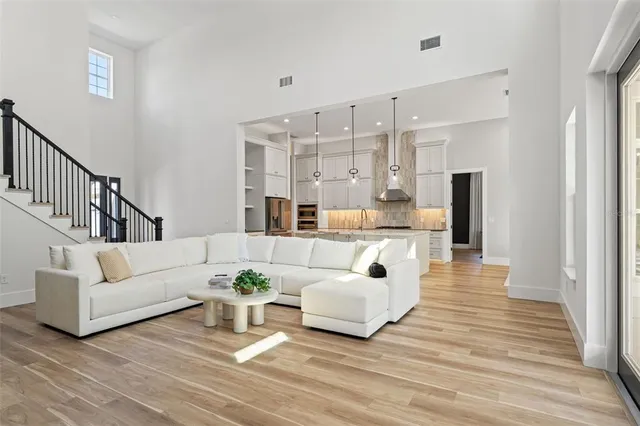 a kitchen with stainless steel appliances kitchen island granite countertop a table and chairs in it