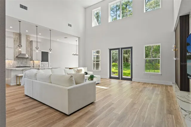 a kitchen with stainless steel appliances kitchen island granite countertop a stove a sink and a white cabinets