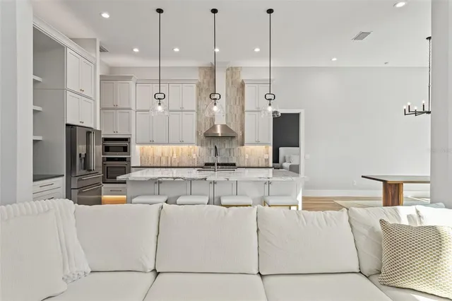 a kitchen with granite countertop a sink stove and cabinets