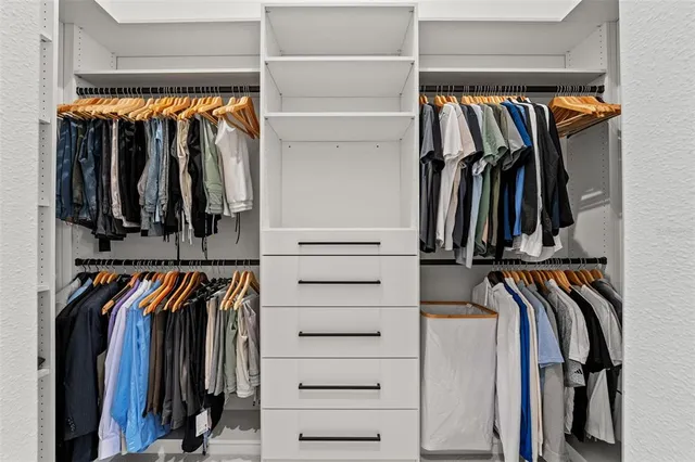 a view of a bedroom with wooden floor and cabinet
