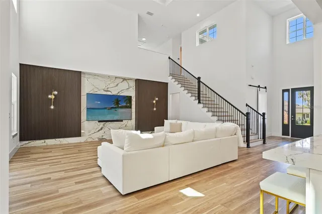 a living room with stainless steel appliances kitchen island granite countertop furniture and a view of living room