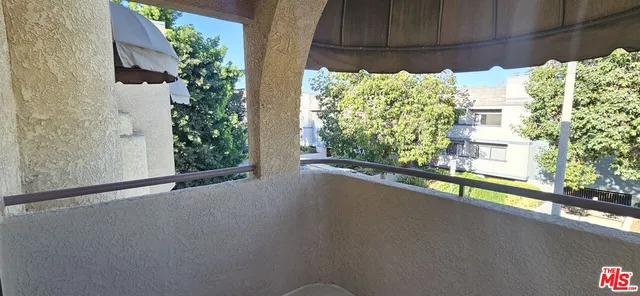 an empty room with wooden floor and a window