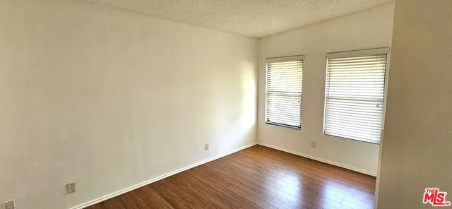 a bathroom with a granite countertop toilet sink and mirror