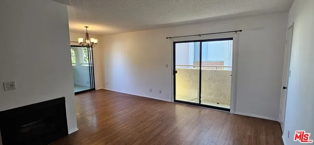 a view of a room with wooden floor and windows