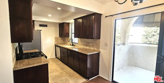 a view of a room with a large window and wooden floor
