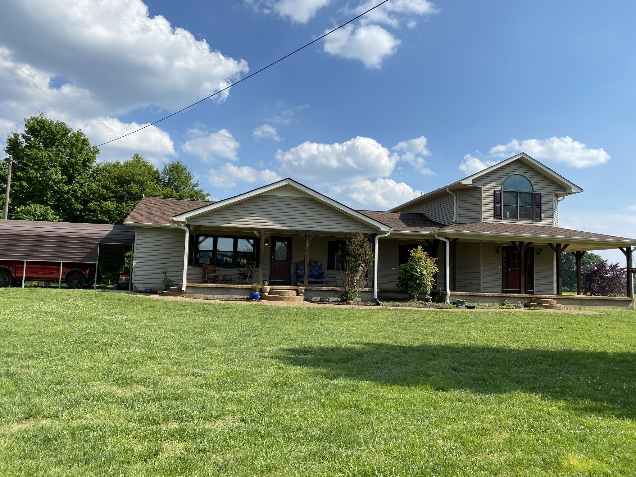 a view of a house with a yard and sitting area