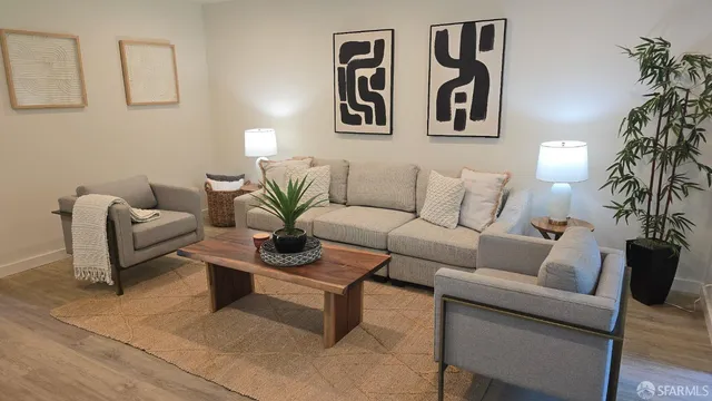 a living room with furniture and a potted plant