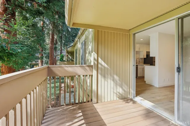 a view of a balcony with wooden floor and stairs