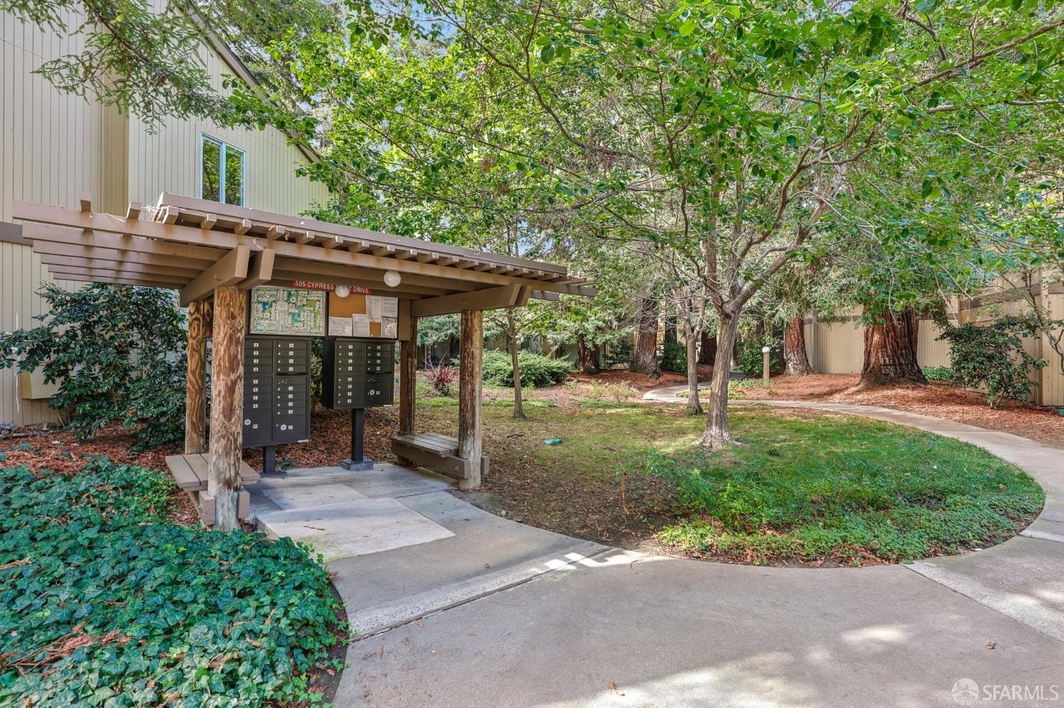 505 Cypress Point Drive, Unit 40 Mountain View, CA 94043 - Photo 27 of 34 a view of a patio with table and chairs under an umbrella