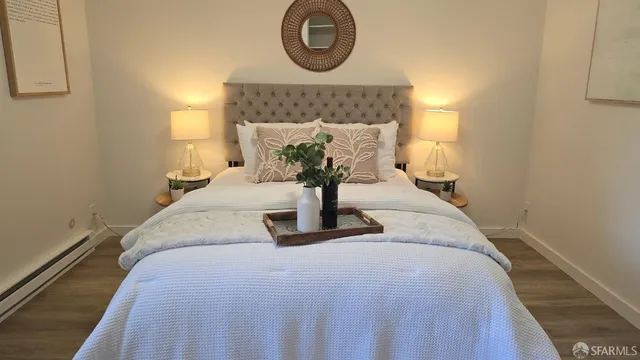 a bedroom with bed and a night stand