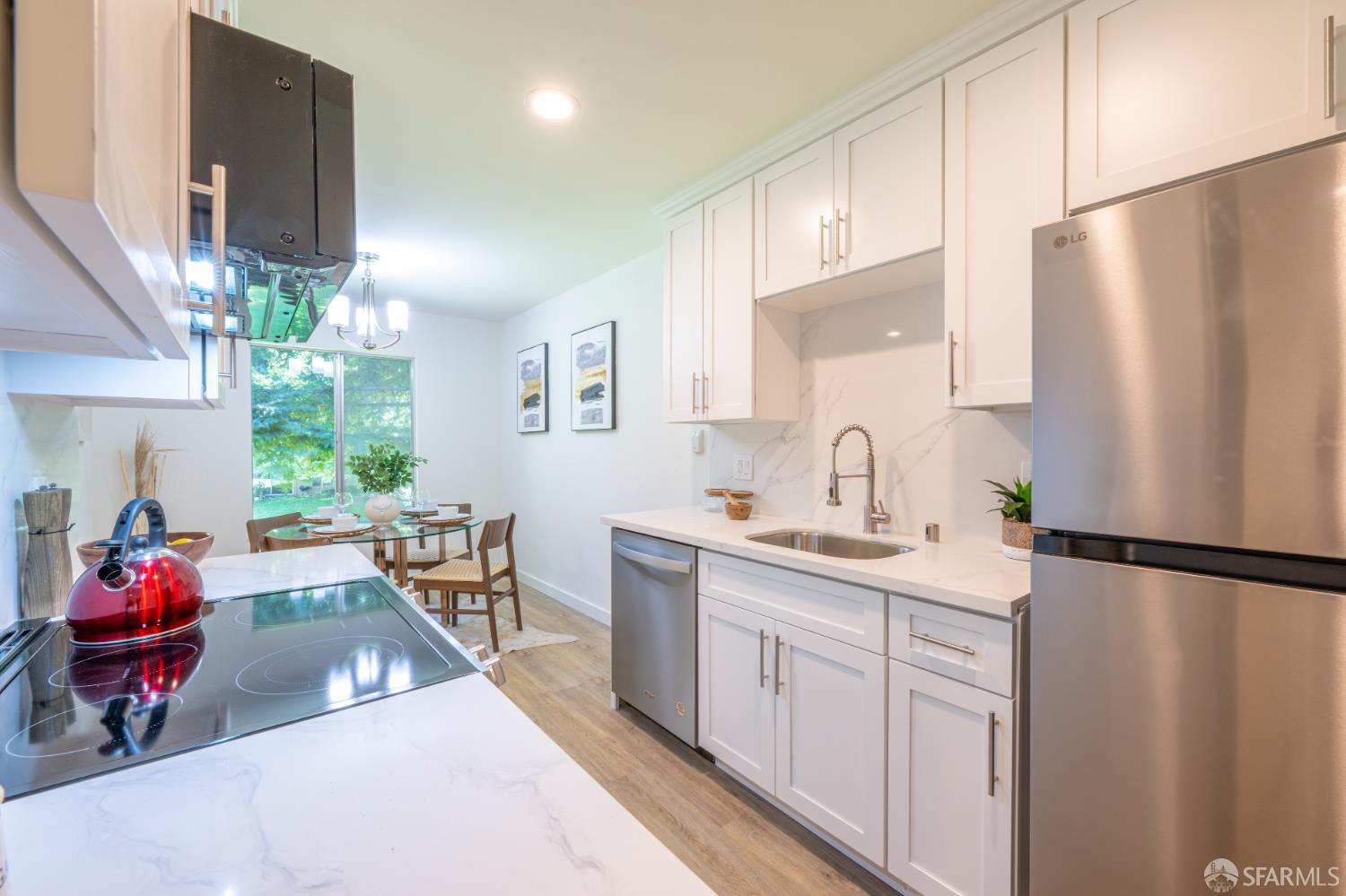 505 Cypress Point Drive, Unit 40 Mountain View, CA 94043 - Photo 9 of 34 a kitchen with stainless steel appliances granite countertop a refrigerator sink and white cabinets