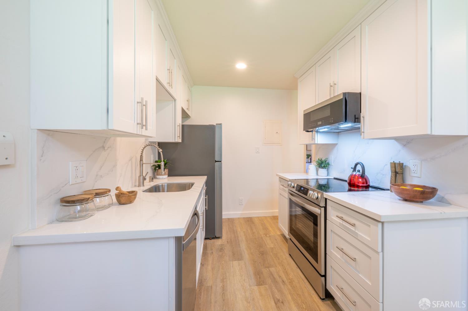 505 Cypress Point Drive, Unit 40 Mountain View, CA 94043 - Photo 10 of 34 a kitchen with a sink a stove and cabinets