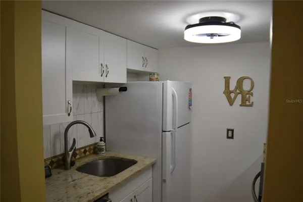 a kitchen with a stove and a refrigerator