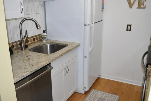 a kitchen with a sink and cabinets