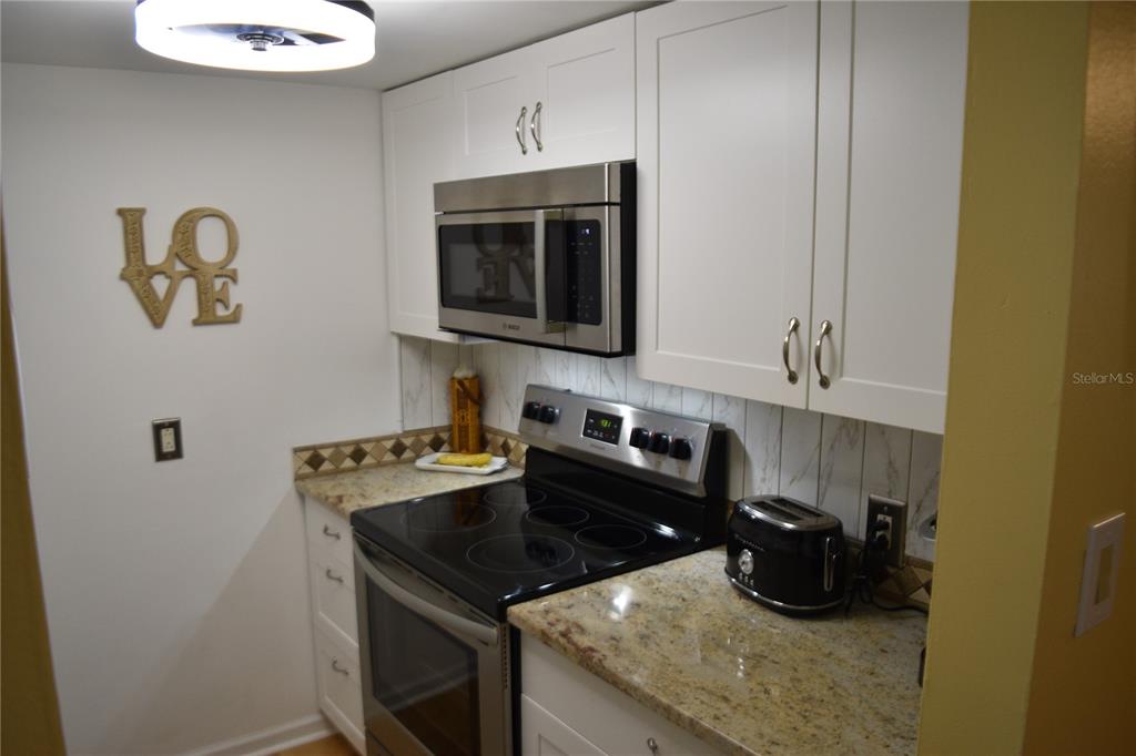 4746 Azalea Drive, Unit 208C New Port Richey, FL 34652 - Photo 19 of 56 a kitchen with a sink and cabinets