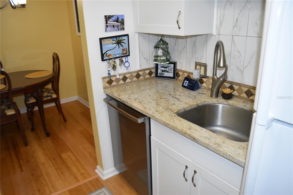4746 Azalea Drive, Unit 208C New Port Richey, FL 34652 - Photo 20 of 56 a kitchen with a sink and a stove with wooden floor
