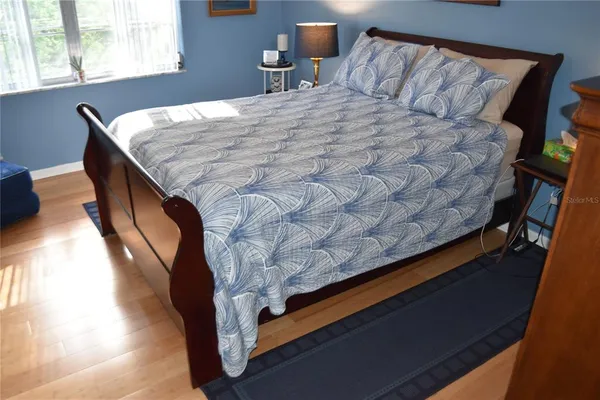 a bedroom with a bed and a window