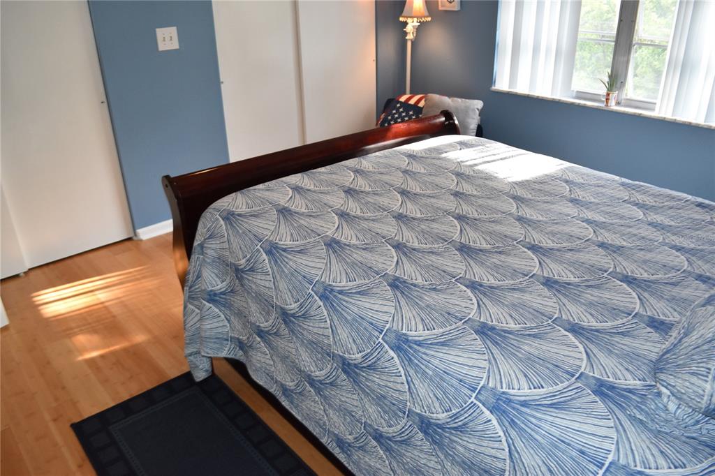 4746 Azalea Drive, Unit 208C New Port Richey, FL 34652 - Photo 27 of 56 a bedroom with a bed and a window