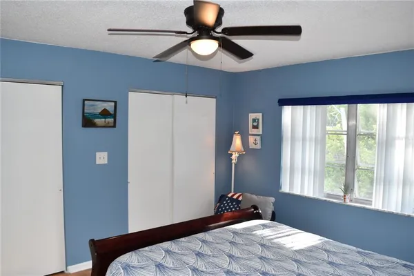 a bedroom with a bed and a flat screen television