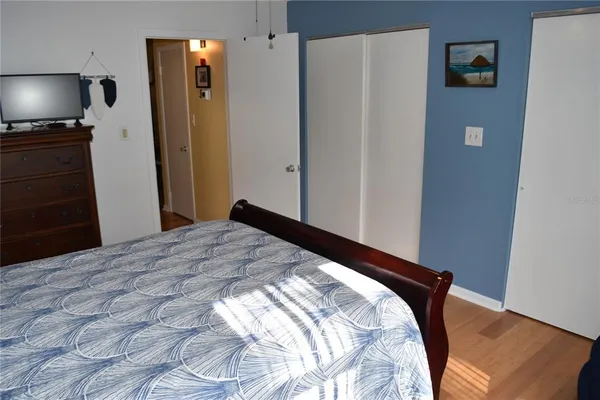 a bedroom with a bed and flat screen tv