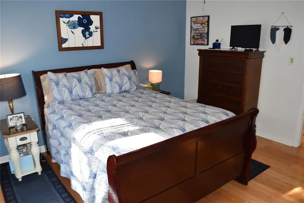 a bedroom with a bed and a mirror