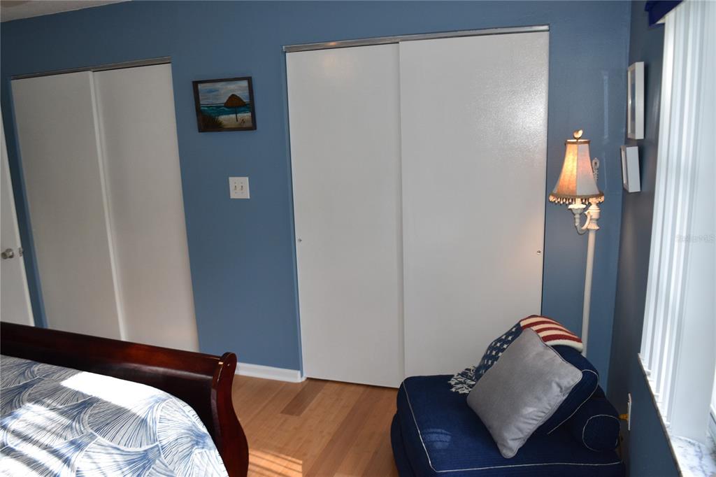 4746 Azalea Drive, Unit 208C New Port Richey, FL 34652 - Photo 33 of 56 a bedroom with a bed and a mirror