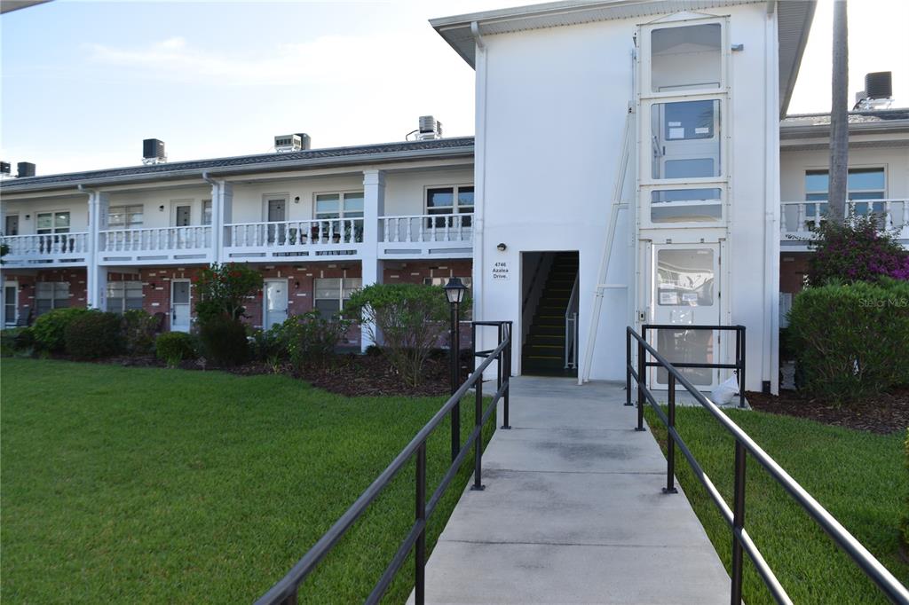 4746 Azalea Drive, Unit 208C New Port Richey, FL 34652 - Photo 45 of 56 a view of a house with a backyard