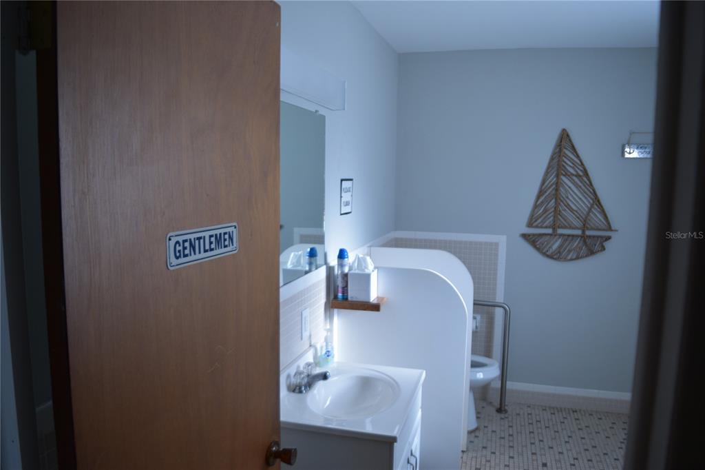 4746 Azalea Drive, Unit 208C New Port Richey, FL 34652 - Photo 49 of 56 a bathroom with a sink and a mirror