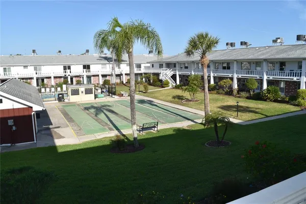 a view of a house with a swimming pool and sitting area