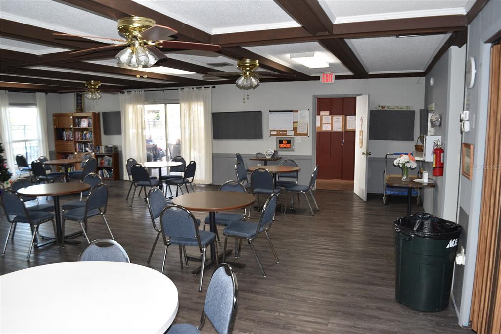 4746 Azalea Drive, Unit 208C New Port Richey, FL 34652 - Photo 52 of 56 a view of a dining room with furniture window and wooden floor