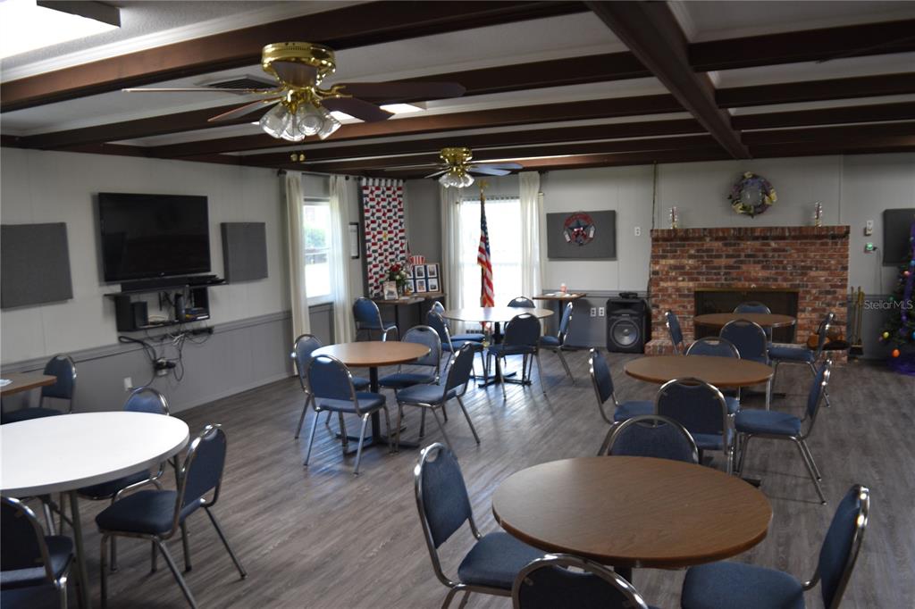 4746 Azalea Drive, Unit 208C New Port Richey, FL 34652 - Photo 54 of 56 a view of a dining room with furniture window and wooden floor