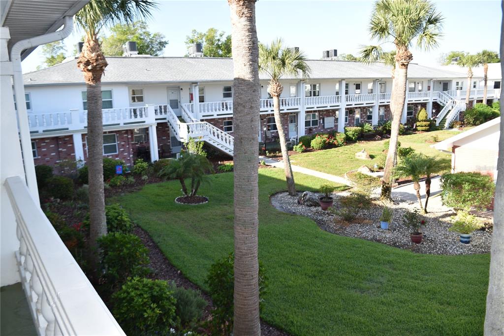 4746 Azalea Drive, Unit 208C New Port Richey, FL 34652 - Photo 6 of 56 a view of a house with a yard